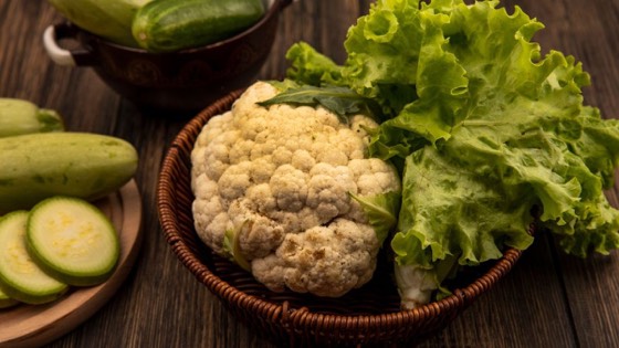 Phool gobhi and greens on a wooden table